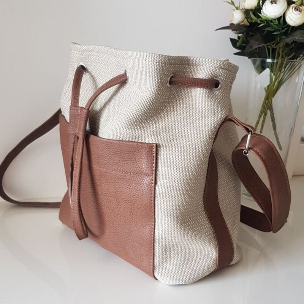 Neutral Woven Two-Tone Bucket Tote Template With Contrast Brown Pebble Trim, Front Slip Compartment And Eyelet Drawstring Top Closure