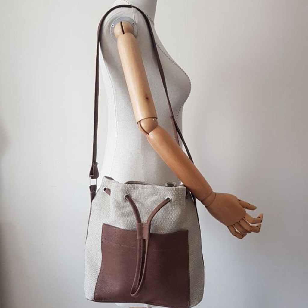 Neutral Woven Two-Tone Bucket Tote Template With Contrast Brown Pebble Trim, Front Slip Compartment And Eyelet Drawstring Top Closure