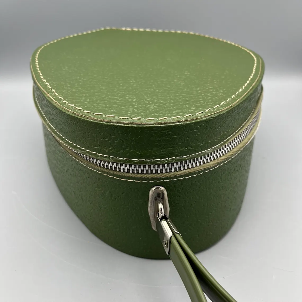Deep Green Pebble Textured Egg Shaped Retro Vanity Case With Wrap-Around Metallic Zip, Cream Lining And Slim Loop Wrist Carry Strap