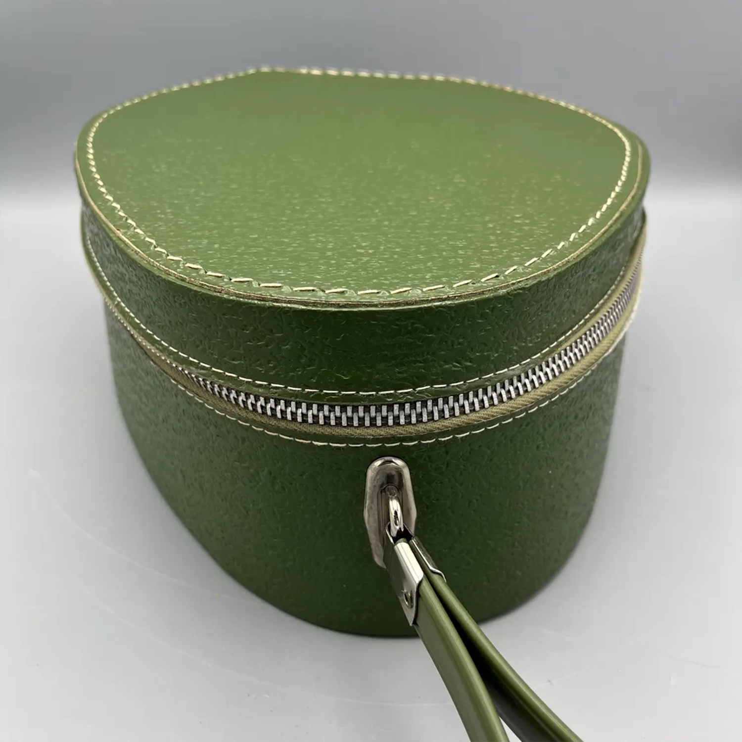 Deep Green Pebble Textured Egg Shaped Retro Vanity Case With Wrap-Around Metallic Zip, Cream Lining And Slim Loop Wrist Carry Strap