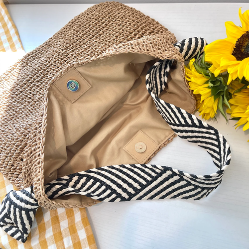 Natural Tan Open Weave Slouchy Tote With Striped Black White Fabric Shoulder Band, Snap Fastener Flap And Smooth Neutral Inner Lining