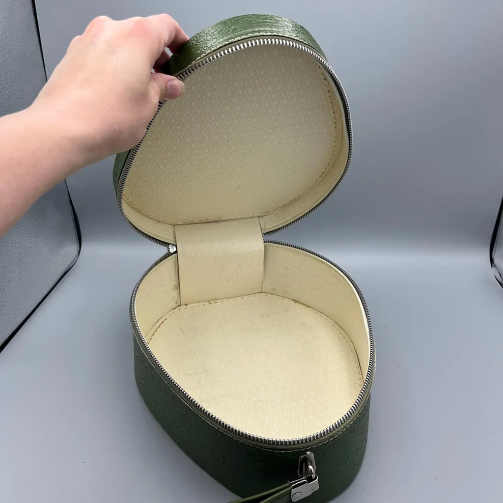 Deep Green Pebble Textured Egg Shaped Retro Vanity Case With Wrap-Around Metallic Zip, Cream Lining And Slim Loop Wrist Carry Strap