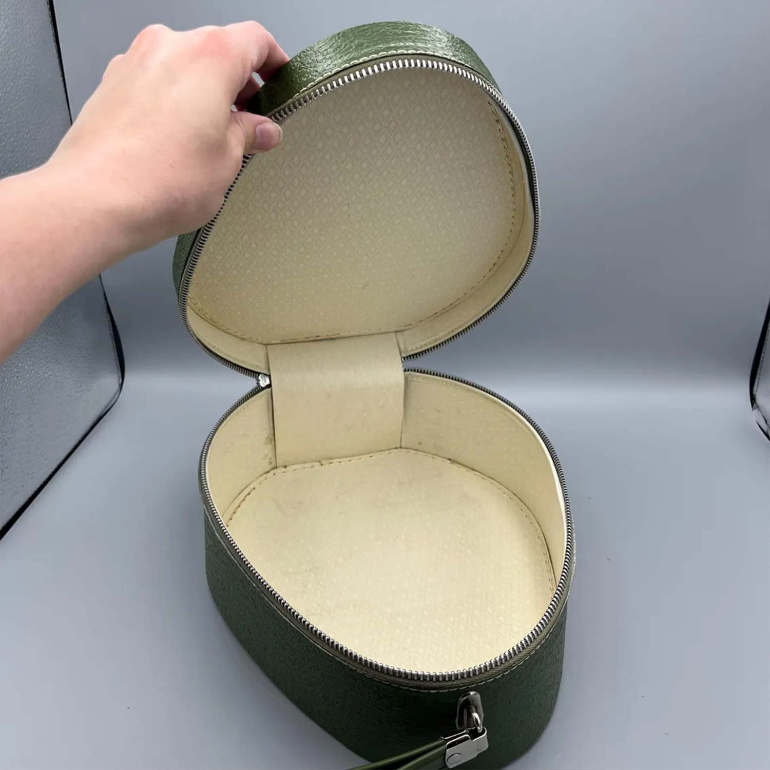 Deep Green Pebble Textured Egg Shaped Retro Vanity Case With Wrap-Around Metallic Zip, Cream Lining And Slim Loop Wrist Carry Strap